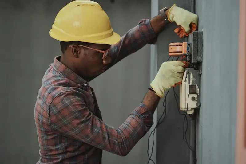 Electrician installing electrical distribution equipment